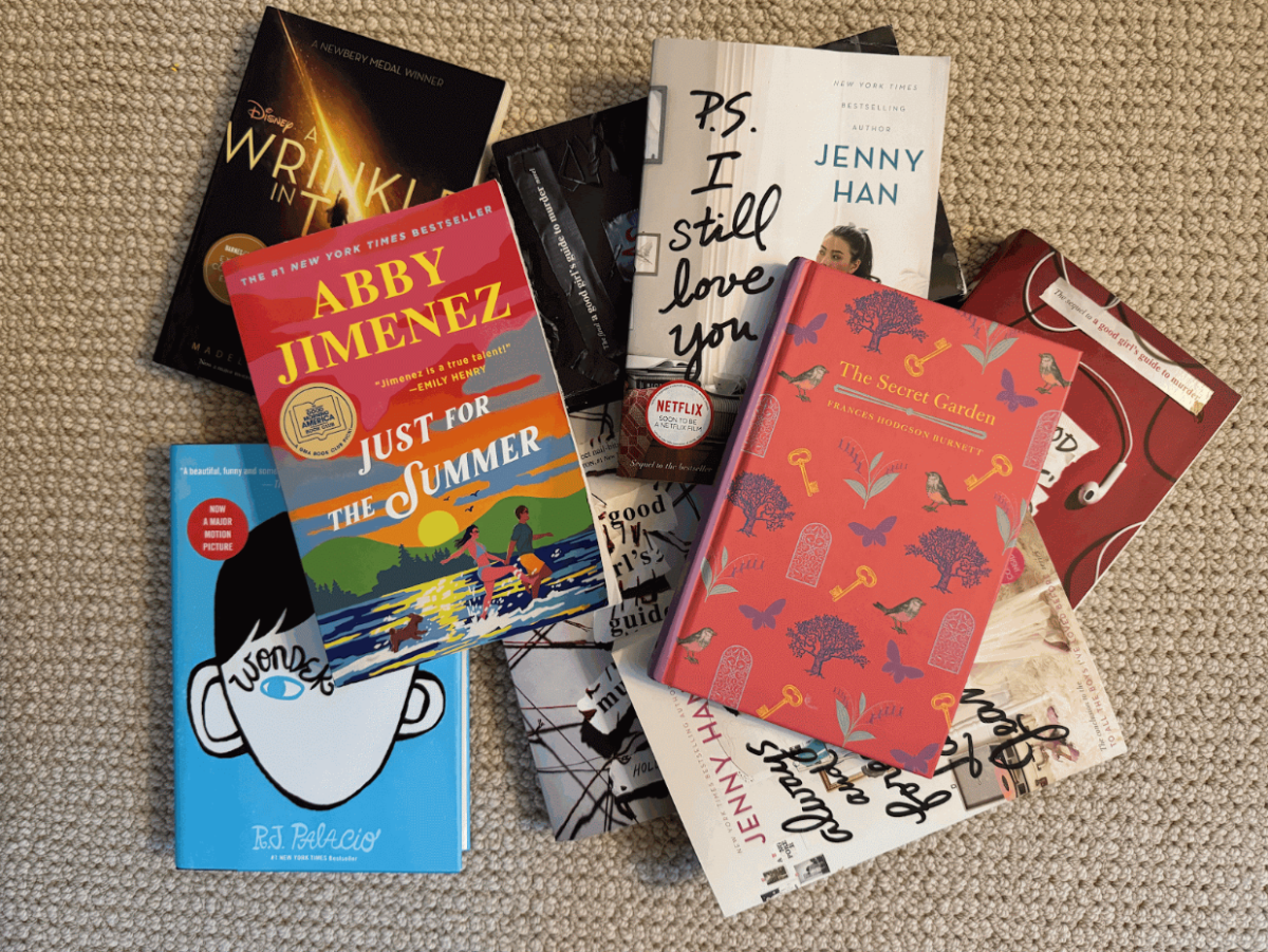 Several classic and newer/recently popular books lay arranged in a pattern on the floor.